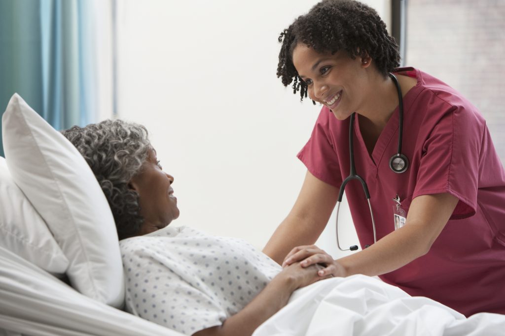 african american nurse comforting patient